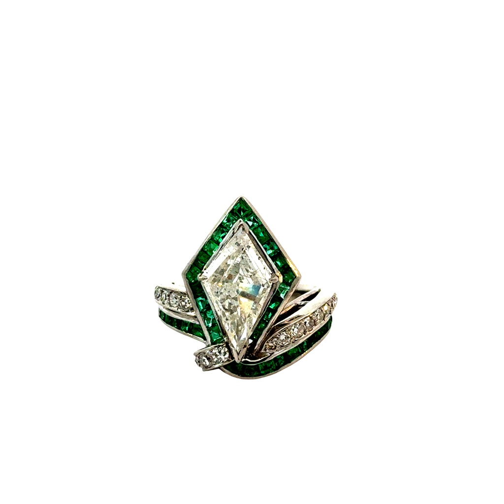Platinum Ring With A Kite Shaped Diamond And Small Emerald And Diamond Side Stones 