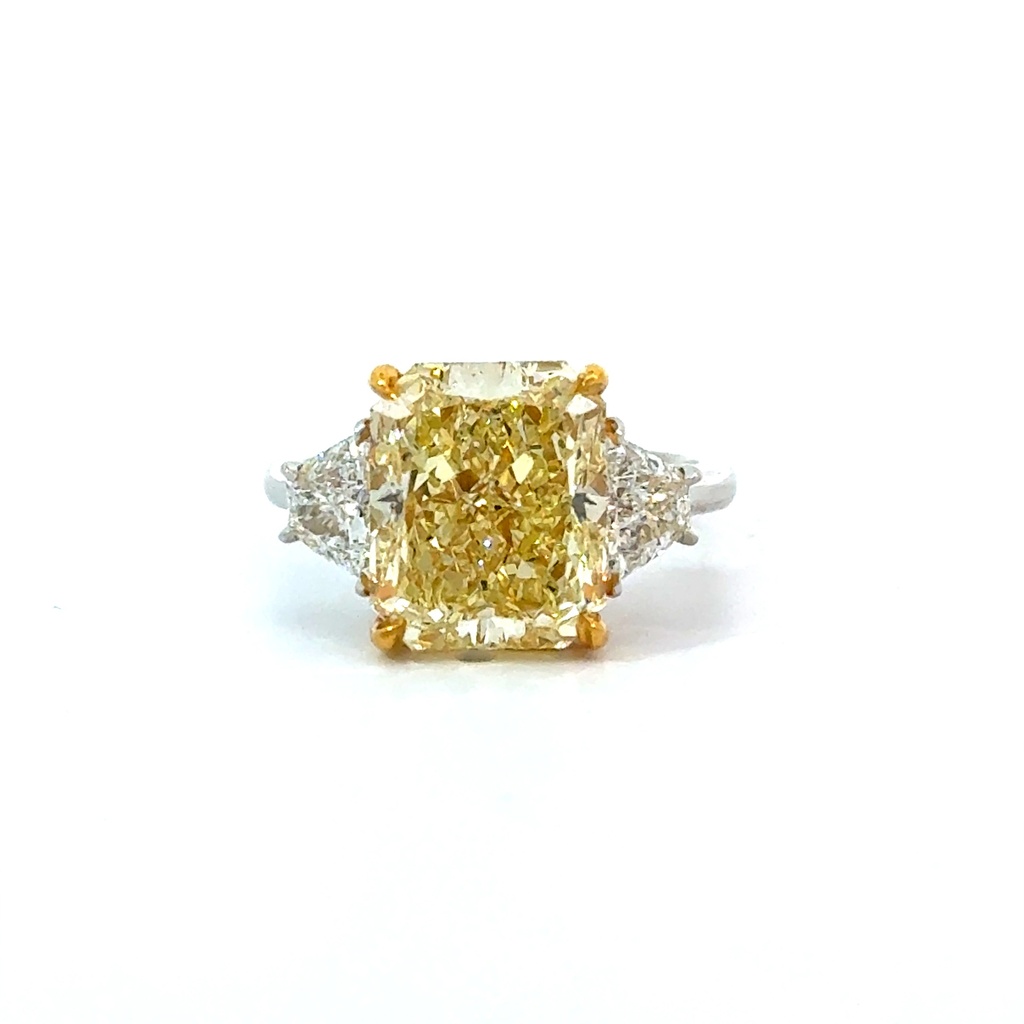 Platinum and 18Kt Yellow Gold Ring With A Radiant Cut Diamond Weighing 6.20ct and (2) Trapezoid Diamonds Weighing 0.85ct