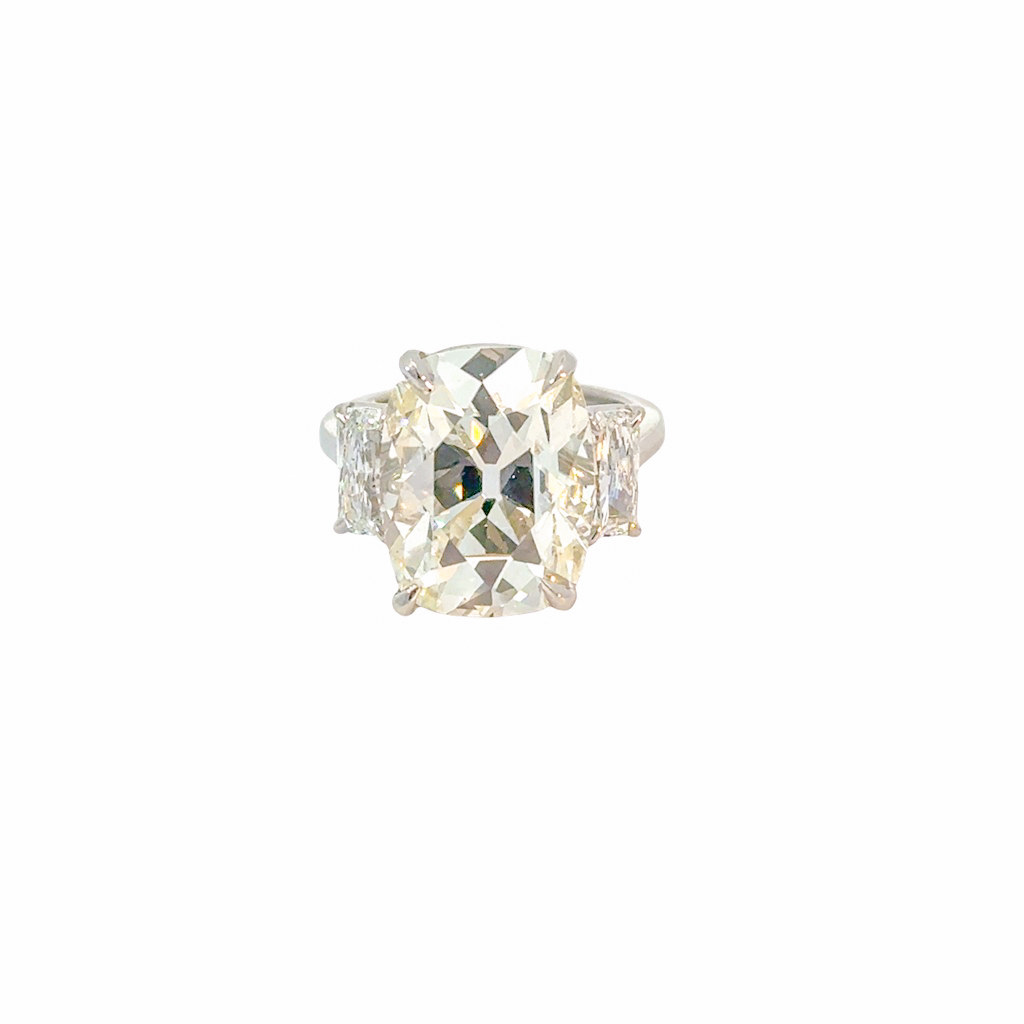 Platinum Three Stone Ring With A Cushion Cut Diamond Weighing 10.75ct And (2) Radiant Cut Diamonds Weighing 1.29ct