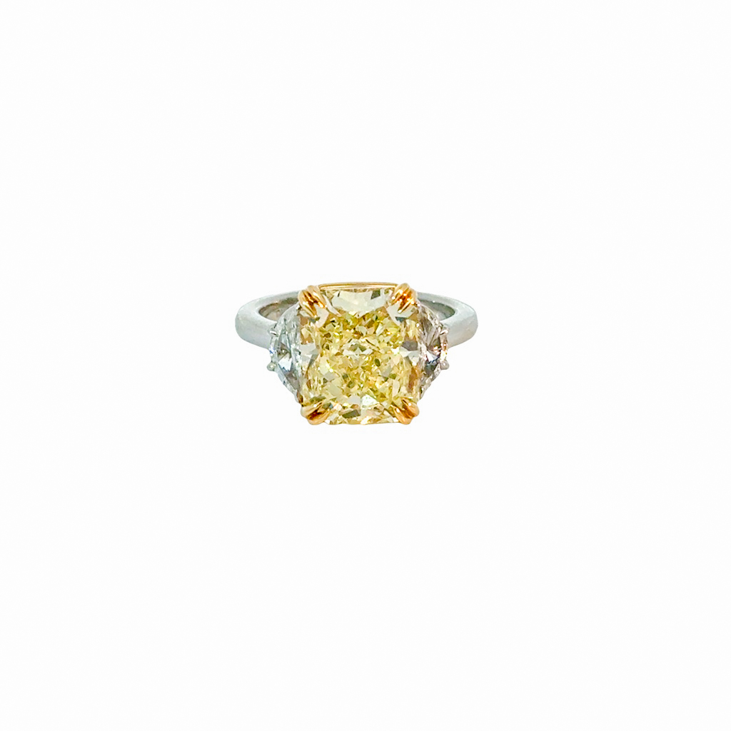 Platinum and 18Kt Yellow Gold Three Stone Ring With A Radiant Yellow Diamond Weighing 5.75ct And (2) Half Moon Diamonds Weighing 0.43ct